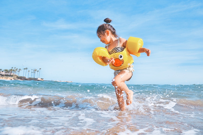 child-playing-in-ocean-on-beach