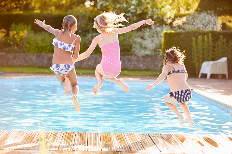 children jumping in a pool